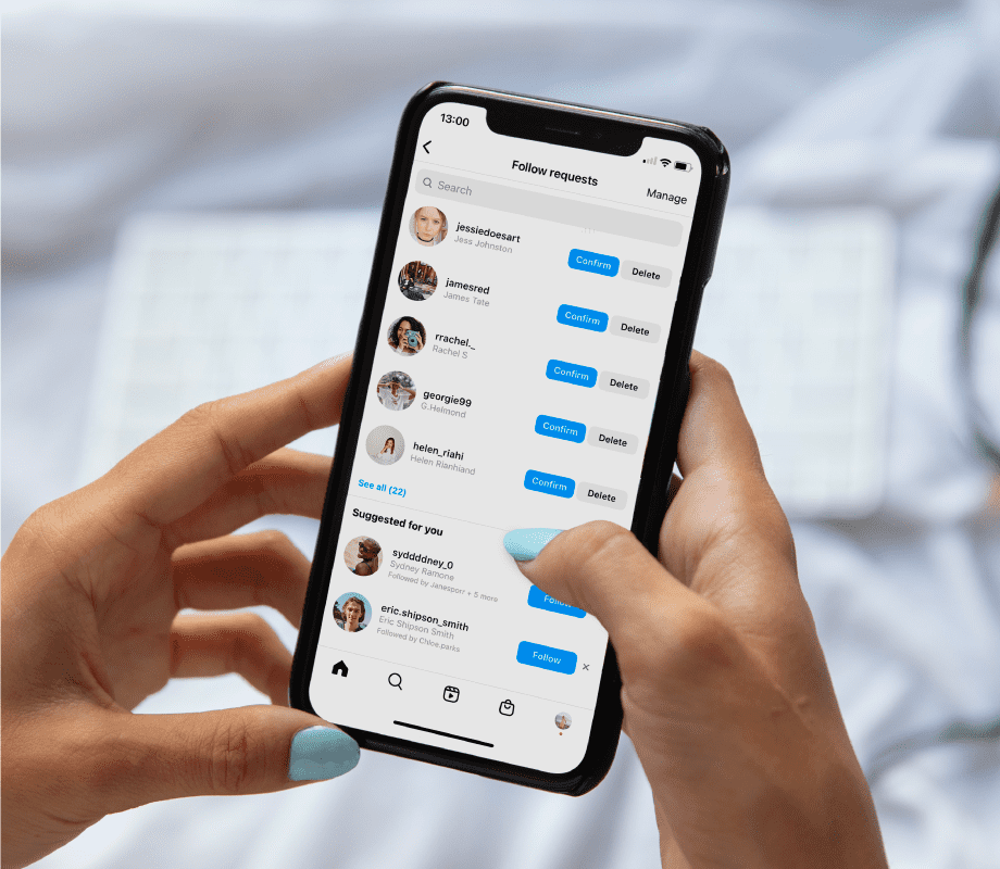 Hands holding phone, accepting friend requests on Instagram  